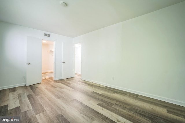 4939 Americana Dr Unit 106, Annandale, VA 22003 - unfurnished bedroom with wood finished floors, a spacious closet, and a closet