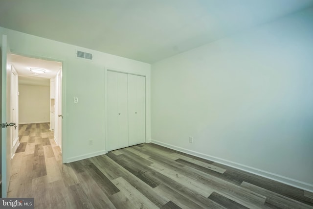 4939 Americana Dr Unit 106, Annandale, VA 22003 - unfurnished bedroom featuring wood finished floors and a closet