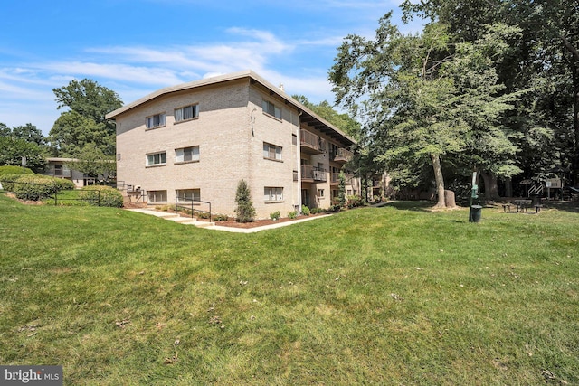 4939 Americana Dr Unit 106, Annandale, VA 22003 - view of property exterior with a lawn and brick siding