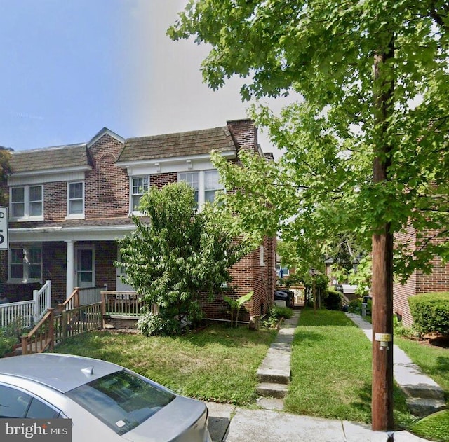 743 E Madison St, Lancaster, PA 17602 - townhome / multi-family property with brick siding, a front yard, mansard roof, and covered porch
