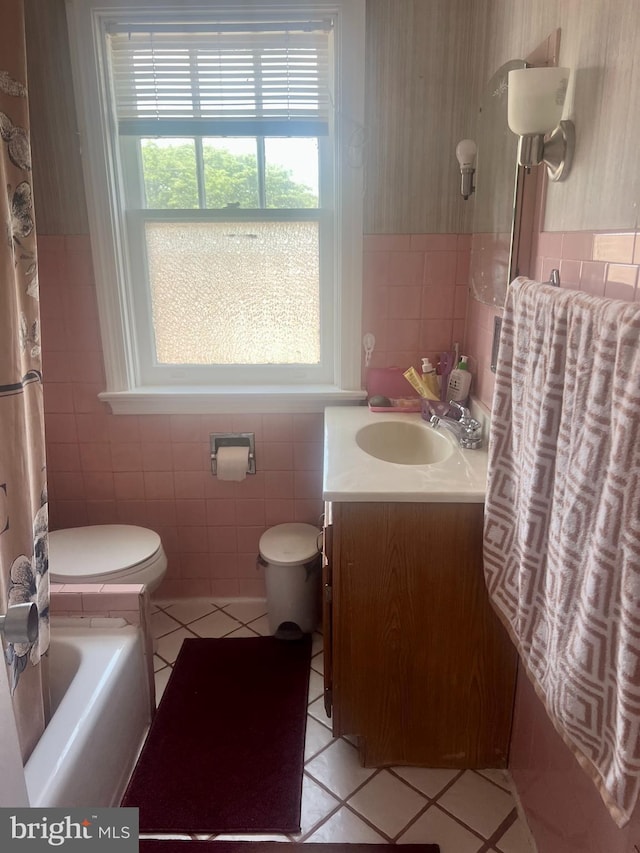 743 E Madison St, Lancaster, PA 17602 - bathroom with tile walls, tile patterned flooring, vanity, and wainscoting