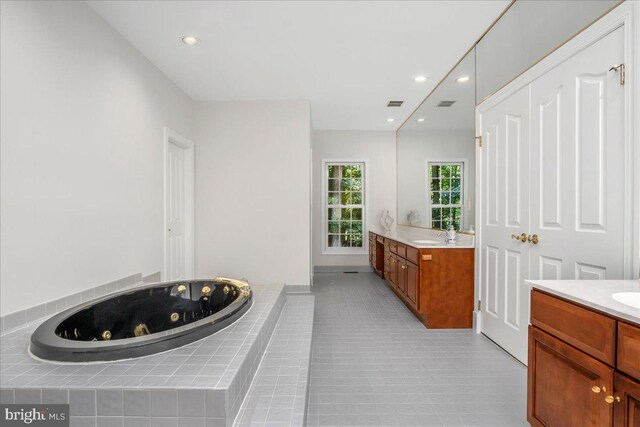 15506 Avery Rd, Rockville, MD 20855 - full bath with two vanities, a tub with jets, recessed lighting, and tile patterned flooring