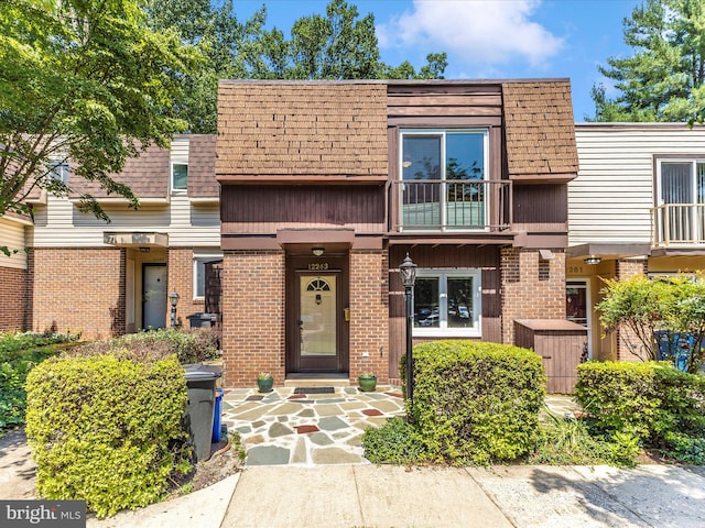 12263 Greenleaf Ave, Potomac, MD 20854 - view of property with brick siding, a balcony, mansard roof, and roof with shingles