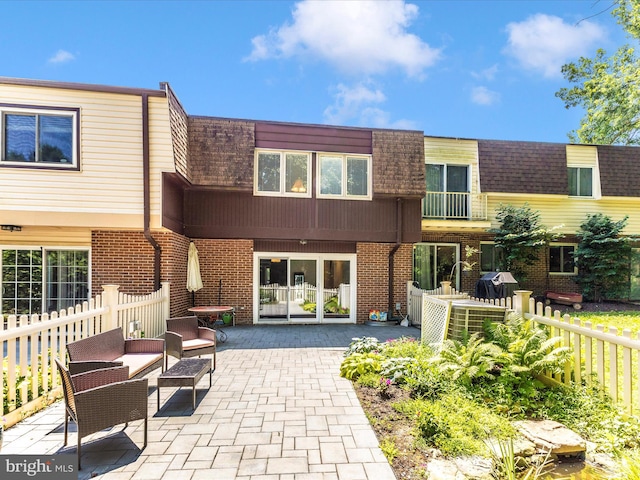 12263 Greenleaf Ave, Potomac, MD 20854 - back of house with a patio, brick siding, mansard roof, and an outdoor hangout area