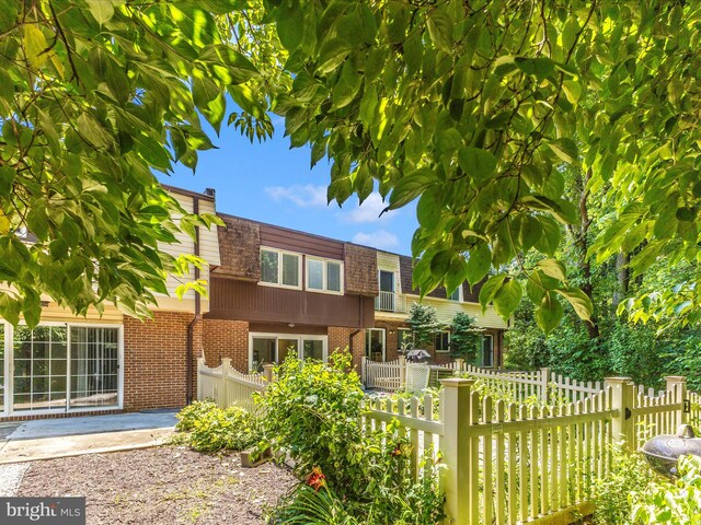 12263 Greenleaf Ave, Potomac, MD 20854 - view of front facade with mansard roof and brick siding