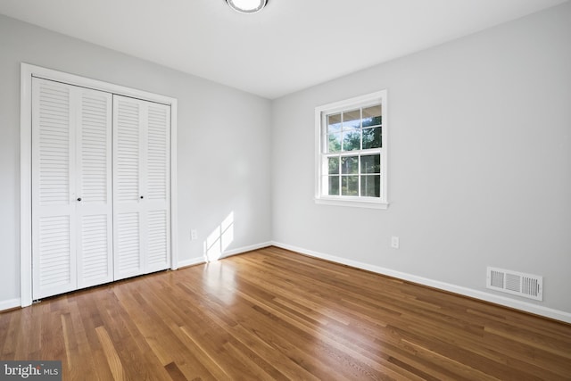906 Danton Ln, Alexandria, VA 22308 - unfurnished bedroom featuring a closet and wood finished floors