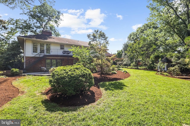 906 Danton Ln, Alexandria, VA 22308 - view of grassy yard with french doors, stairs, a patio area, and a deck