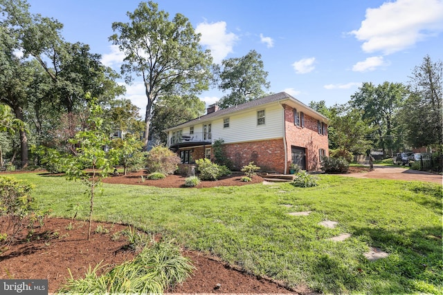 906 Danton Ln, Alexandria, VA 22308 - view of side of home featuring brick siding, an attached garage, a chimney, and a yard