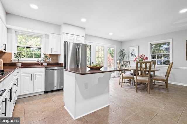 906 Danton Ln, Alexandria, VA 22308 - kitchen featuring appliances with stainless steel finishes, dark countertops, recessed lighting, tasteful backsplash, and white cabinetry