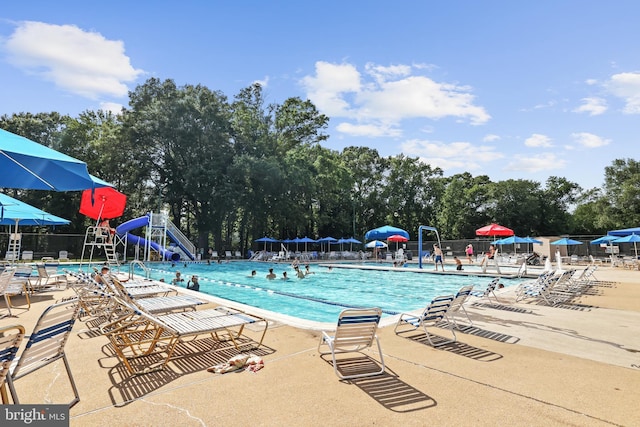 906 Danton Ln, Alexandria, VA 22308 - community pool featuring a water slide, a patio, and view of wooded area