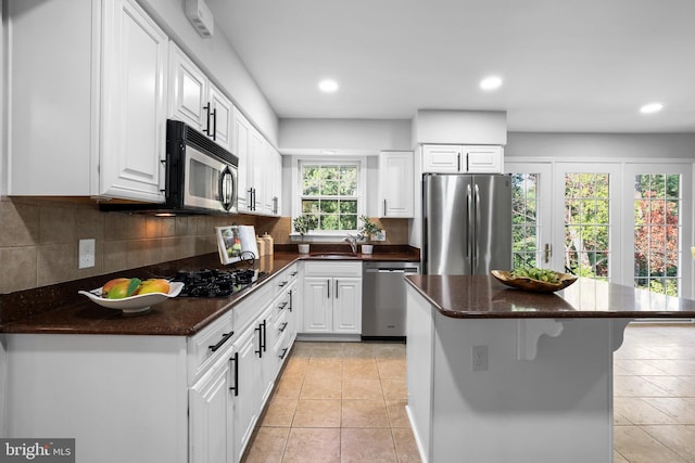 906 Danton Ln, Alexandria, VA 22308 - kitchen featuring stainless steel appliances, white cabinetry, backsplash, light tile patterned floors, and recessed lighting