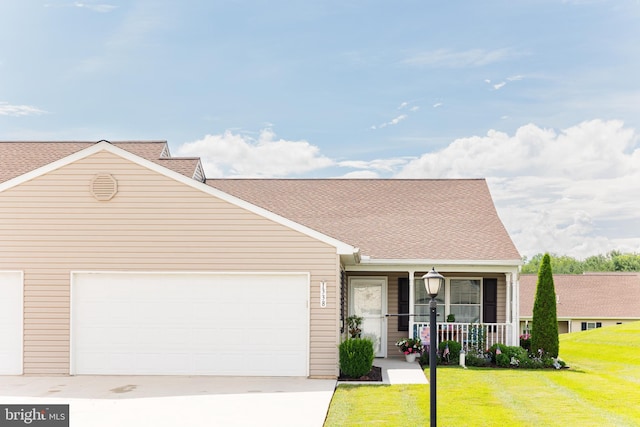 1338 Chami Dr Unit 196, Spring Grove, PA 17362 - view of front of home featuring a porch, driveway, a front lawn, a garage, and a shingled roof
