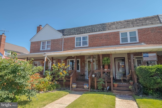 2302 Searles Rd, Dundalk, MD 21222 - view of property with brick siding, covered porch, and a front yard