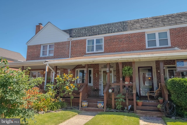 2302 Searles Rd, Dundalk, MD 21222 - multi unit property with brick siding, covered porch, and a chimney