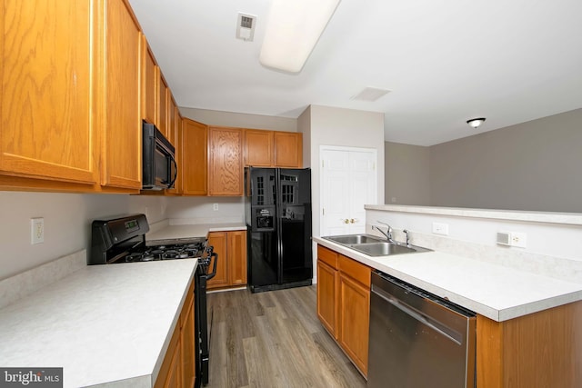 304 Amy Way, Cinnaminson, NJ 08077 - kitchen with black appliances, light countertops, light wood finished floors, and brown cabinetry
