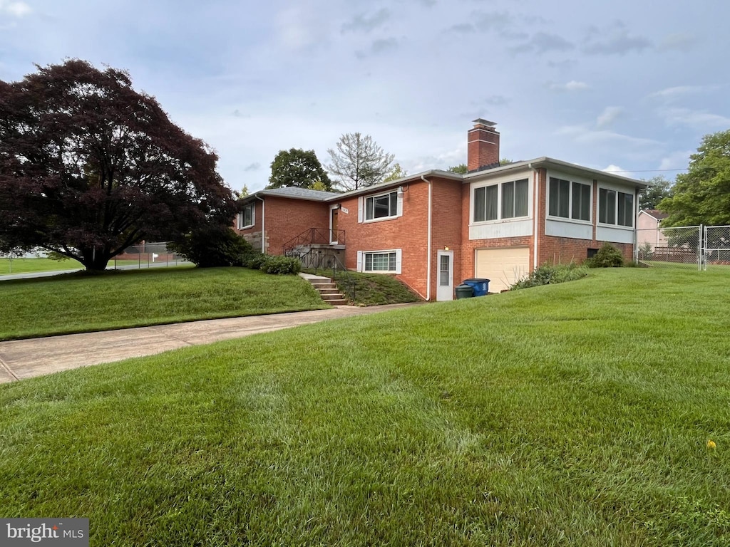 12829 Baker Dr, Silver Spring, MD 20904 - view of side of home with an attached garage, a chimney, and brick siding