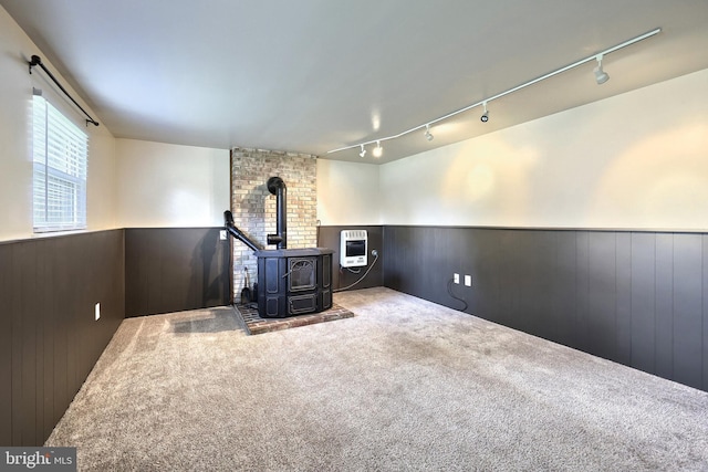 4604 View Dr, Spring Grove, PA 17362 - unfurnished living room with a wood stove, track lighting, a wainscoted wall, carpet flooring, and wooden walls