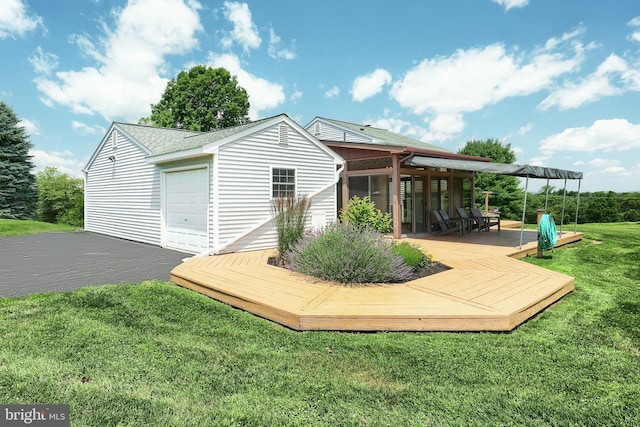 4604 View Dr, Spring Grove, PA 17362 - rear view of property with a sunroom, a deck, a yard, roof with shingles, and a garage
