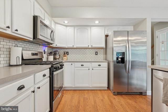 100 Windsor Ct, Richlandtown, PA 18955 - kitchen featuring appliances with stainless steel finishes, white cabinets, light countertops, light wood-style flooring, and backsplash