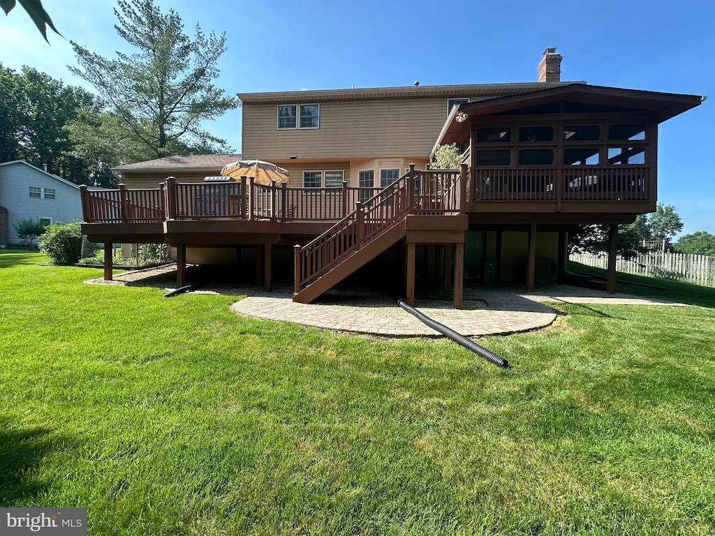 8101 Blake Ct, Bowie, MD 20720 - back of property with a wooden deck, a chimney, a lawn, and stairway