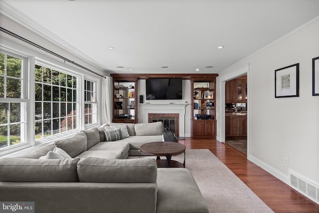 295 Crescent Ave, Moorestown, NJ 08057 - living room with crown molding, dark wood finished floors, a brick fireplace, and recessed lighting