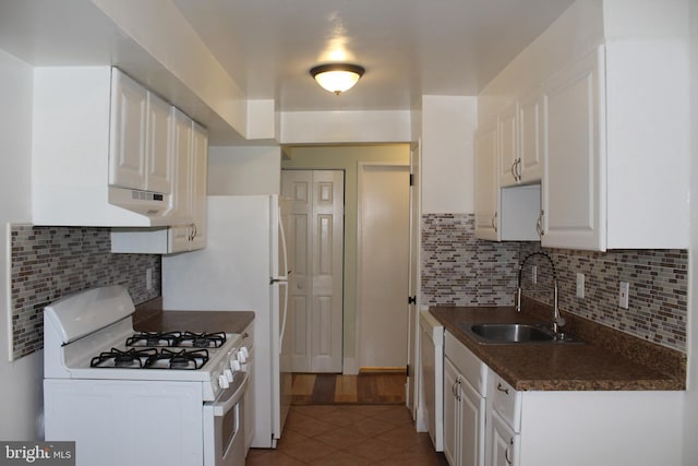 130 Duvall Ln Unit 194-202, Gaithersburg, MD 20877 - kitchen featuring white appliances, dark countertops, tile patterned flooring, white cabinets, and backsplash