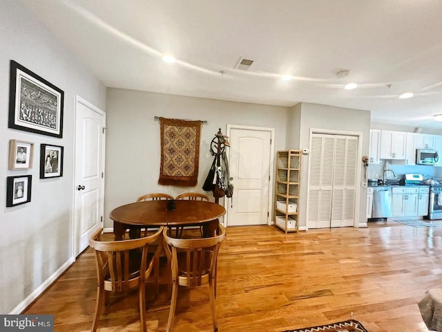 445 Manor Pl NW Unit 3, Washington, DC 20010 - dining space with light wood-style floors and baseboards