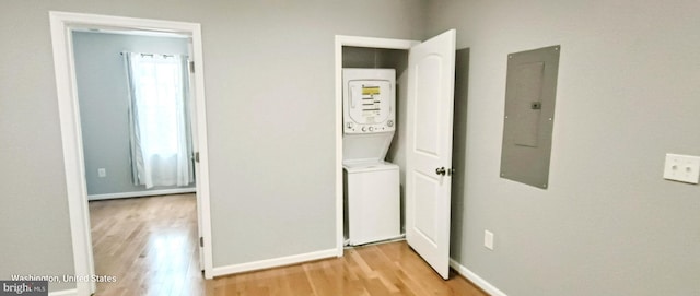 445 Manor Pl NW Unit 3, Washington, DC 20010 - laundry room featuring electric panel, stacked washing machine and dryer, and light wood-style flooring