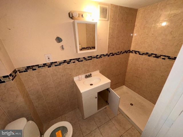 7638 Thouron Ave, Philadelphia, PA 19150 - full bathroom featuring tile walls, a stall shower, tile patterned floors, vanity, and a wainscoted wall