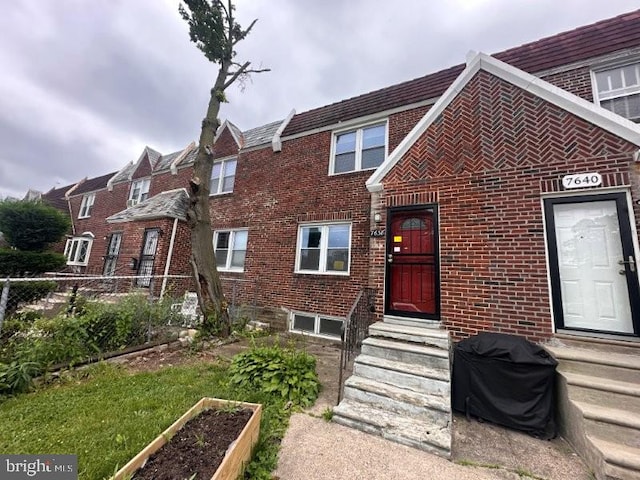 7638 Thouron Ave, Philadelphia, PA 19150 - townhome / multi-family property with brick siding and a vegetable garden