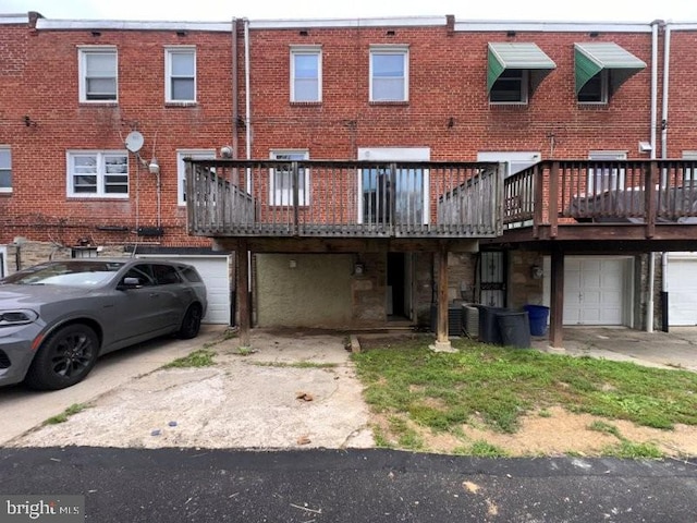 7638 Thouron Ave, Philadelphia, PA 19150 - rear view of property featuring an attached garage, driveway, and brick siding