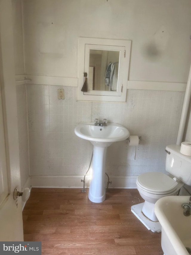 19 E Main St, Richland, PA 17087 - full bathroom featuring a tub to relax in, wood finished floors, and wainscoting