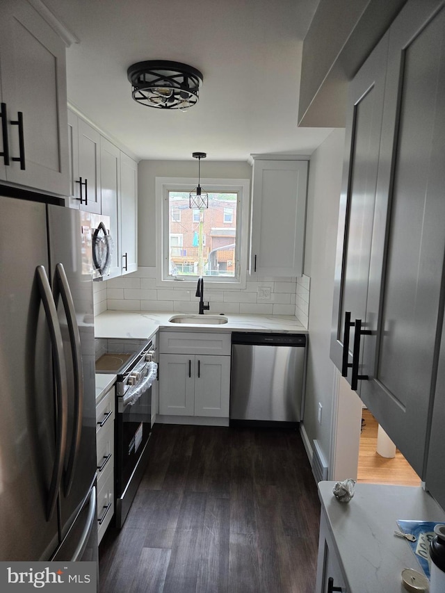 814 4th Ave, Bristol, PA 19007 - kitchen with stainless steel appliances, dark wood-type flooring, tasteful backsplash, and light countertops