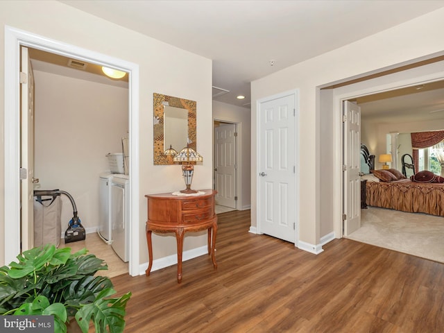 9175 Bealls Farm Rd, Frederick, MD 21704 - corridor with washing machine and clothes dryer, wood finished floors, and recessed lighting