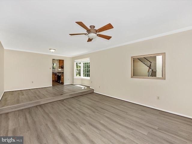 23732 Rolling Fork Way, Gaithersburg, MD 20882 - unfurnished living room with ornamental molding, a ceiling fan, and wood finished floors