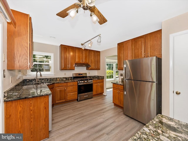 23732 Rolling Fork Way, Gaithersburg, MD 20882 - kitchen with appliances with stainless steel finishes, under cabinet range hood, ceiling fan, dark stone counters, and brown cabinetry