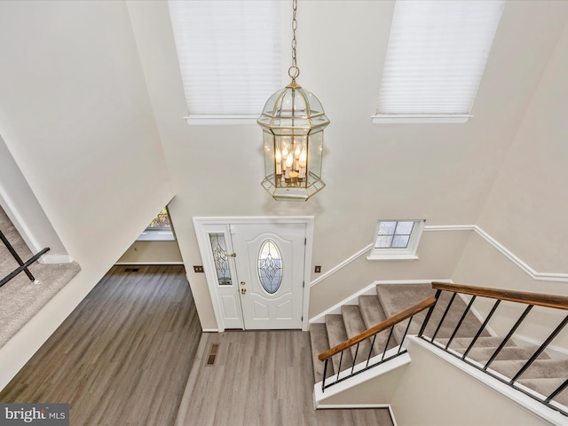 23732 Rolling Fork Way, Gaithersburg, MD 20882 - entryway with a chandelier, a high ceiling, wood finished floors, and stairs