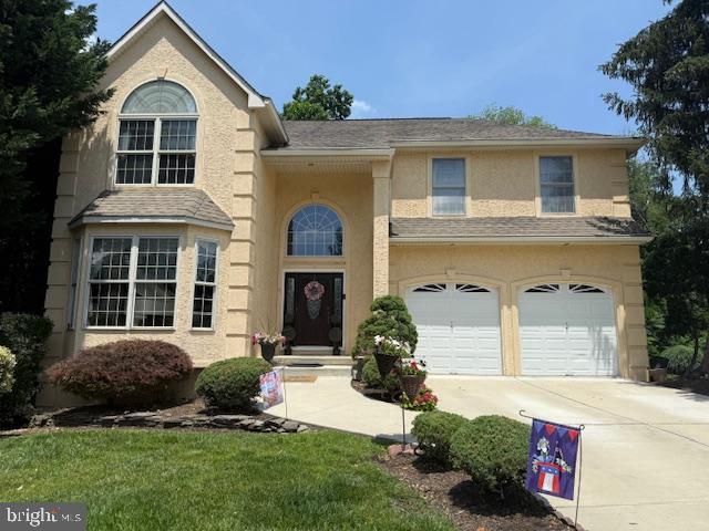 325 Newton Ct, Haddon Township, NJ 08107 - view of front of property with concrete driveway, stucco siding, and an attached garage