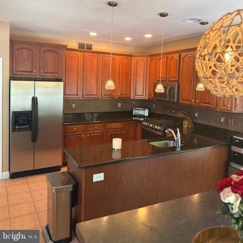 325 Newton Ct, Haddon Township, NJ 08107 - kitchen featuring stainless steel appliances, hanging light fixtures, brown cabinetry, and recessed lighting