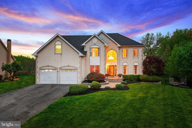 61 Brooks Rd, Moorestown, NJ 08057 - view of front of house with a garage, asphalt driveway, a yard, and stucco siding
