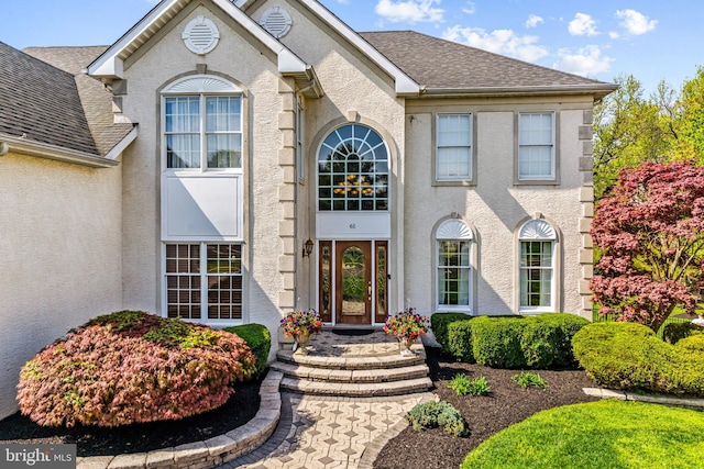 61 Brooks Rd, Moorestown, NJ 08057 - view of exterior entry with stucco siding and a shingled roof