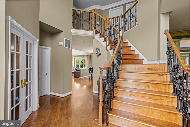61 Brooks Rd, Moorestown, NJ 08057 - staircase with wood finished floors, french doors, and a high ceiling