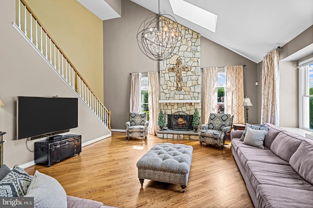 61 Brooks Rd, Moorestown, NJ 08057 - living area featuring a skylight, a chandelier, high vaulted ceiling, wood finished floors, and a fireplace