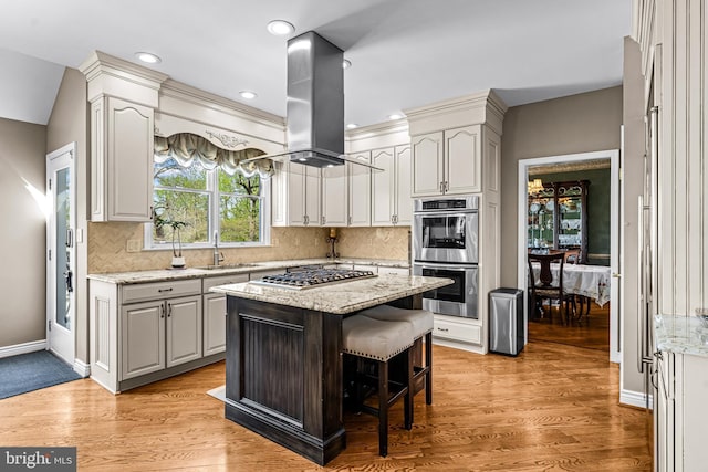 61 Brooks Rd, Moorestown, NJ 08057 - kitchen featuring appliances with stainless steel finishes, island exhaust hood, tasteful backsplash, light wood-type flooring, and recessed lighting