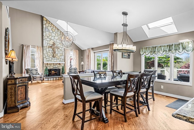 61 Brooks Rd, Moorestown, NJ 08057 - dining room with a skylight, a chandelier, wood finished floors, and vaulted ceiling