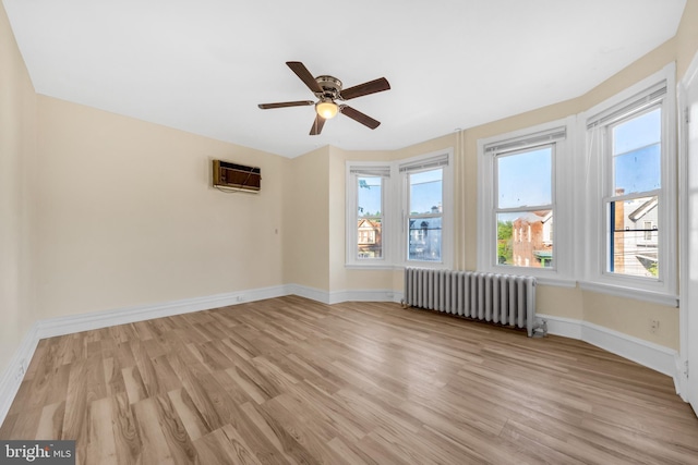 100 Powelton Ave, Lansdowne, PA 19050 - spare room featuring radiator, light wood finished floors, a wall unit AC, and a ceiling fan