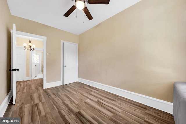 100 Powelton Ave, Lansdowne, PA 19050 - unfurnished bedroom featuring a chandelier, wood finished floors, ceiling fan, and radiator