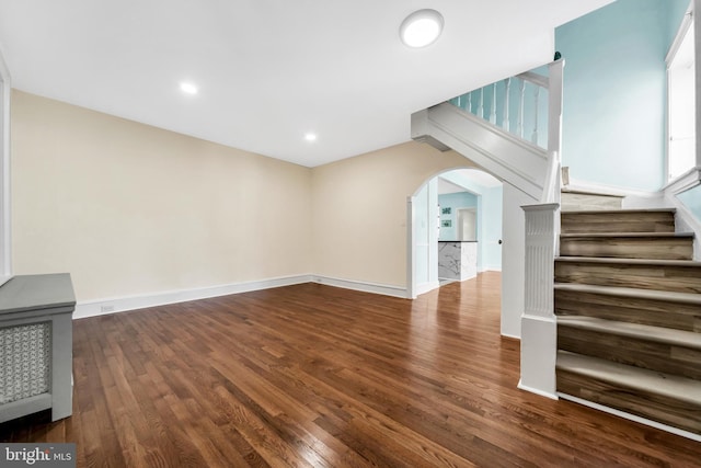 100 Powelton Ave, Lansdowne, PA 19050 - unfurnished living room featuring arched walkways, wood finished floors, and stairs