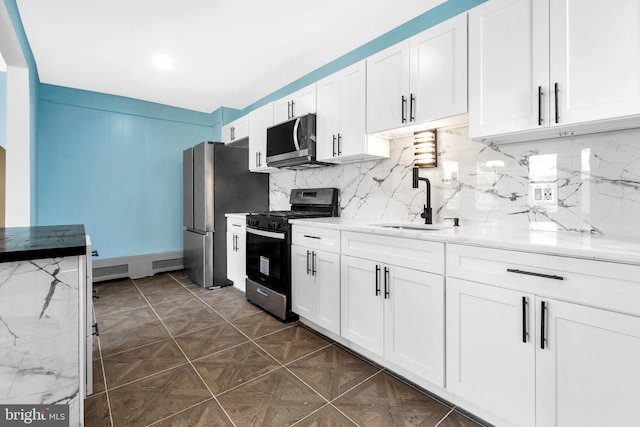 100 Powelton Ave, Lansdowne, PA 19050 - kitchen with appliances with stainless steel finishes, white cabinetry, decorative backsplash, and light stone countertops