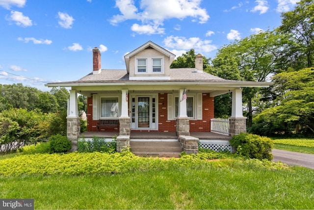 615 Convent Rd, Aston, PA 19014 - view of front facade featuring a chimney, a porch, and brick siding